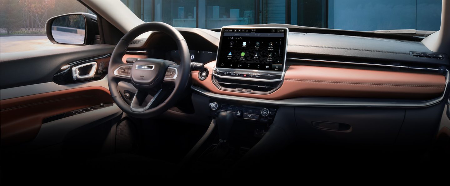 The steering wheel, Uconnect touchscreen and dashboard in the 2022 Jeep Compass.